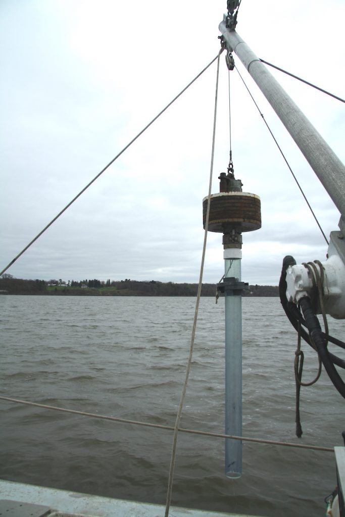 Sediment corer showing weight at the top and 2 meter clear core.